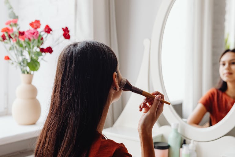 A woman applying makeup for a business or branding photoshoot in Ayrshire Scotland