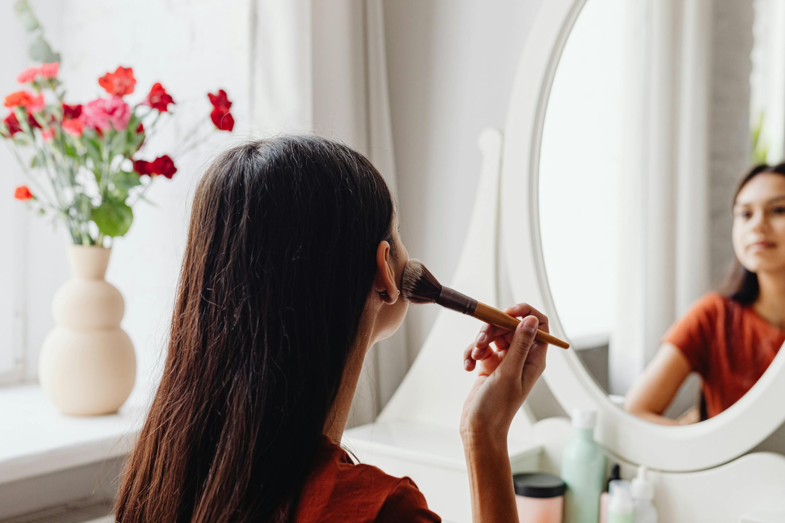 A woman applying makeup for a business or branding photoshoot in Ayrshire Scotland